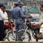 This image shows a traffic police official interacting with a citizen. — Traffic Police Punjab website