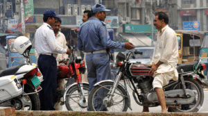 This image shows a traffic police official interacting with a citizen. — Traffic Police Punjab website